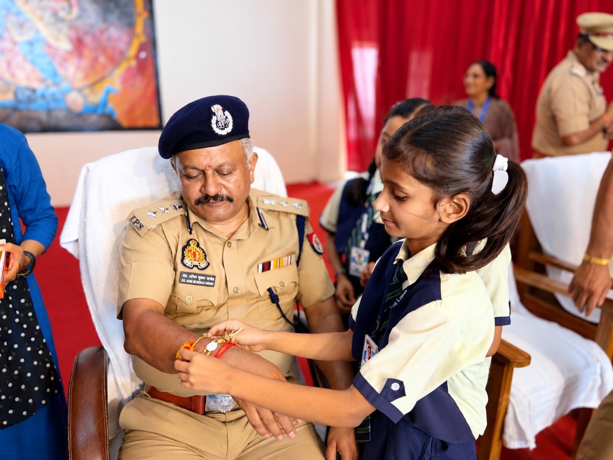 A Mount Litera Zee School Ramnagar student tying a rakhi on a police officer's wrist during the Raksha Bandhan celebration